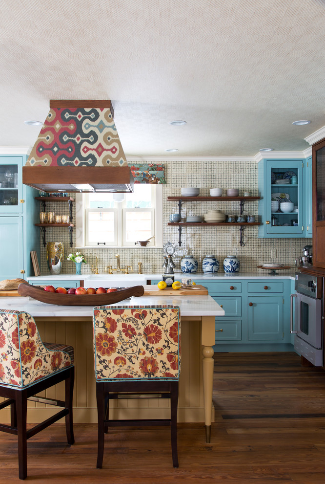 This is an example of an eclectic l-shaped kitchen in Denver with a farmhouse sink, shaker cabinets, blue cabinets, beige splashback, dark hardwood floors and with island.