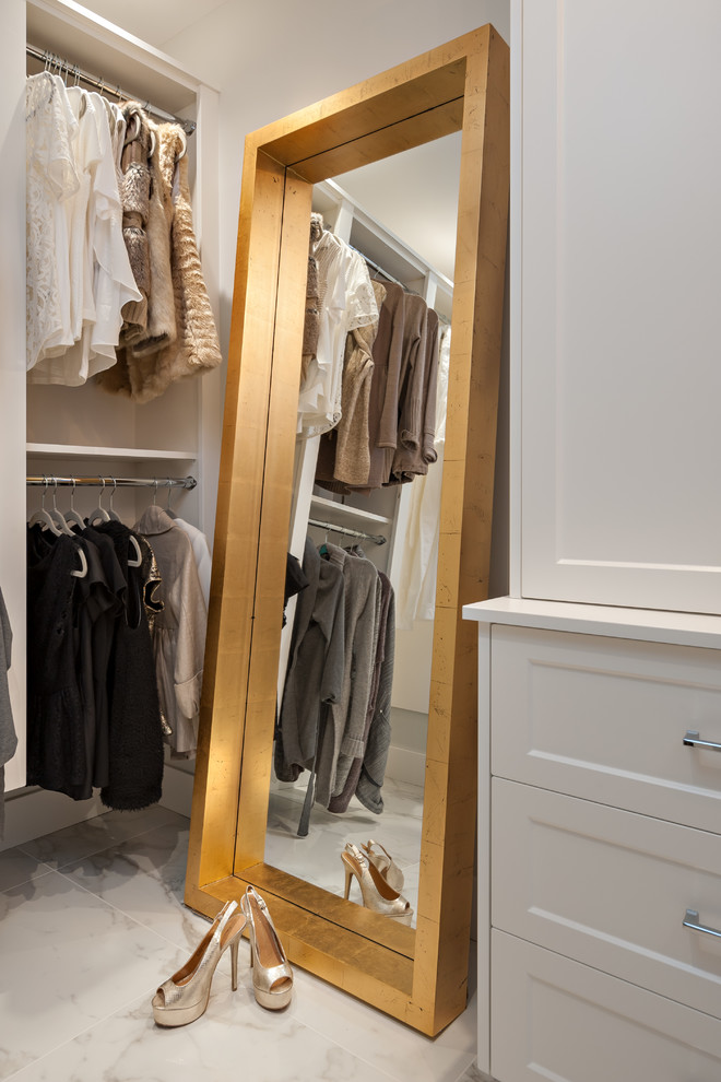 Inspiration for a mid-sized transitional gender-neutral walk-in wardrobe in Vancouver with shaker cabinets, white cabinets and porcelain floors.