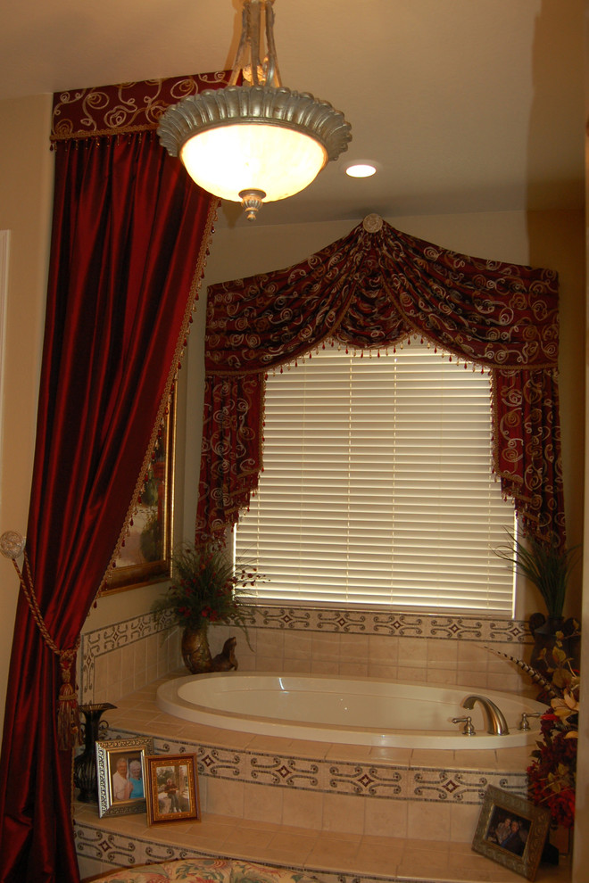Example of a mid-sized transitional master beige tile and stone tile ceramic tile doorless shower design in Phoenix with raised-panel cabinets, dark wood cabinets, a hot tub, a one-piece toilet, beige walls and a drop-in sink