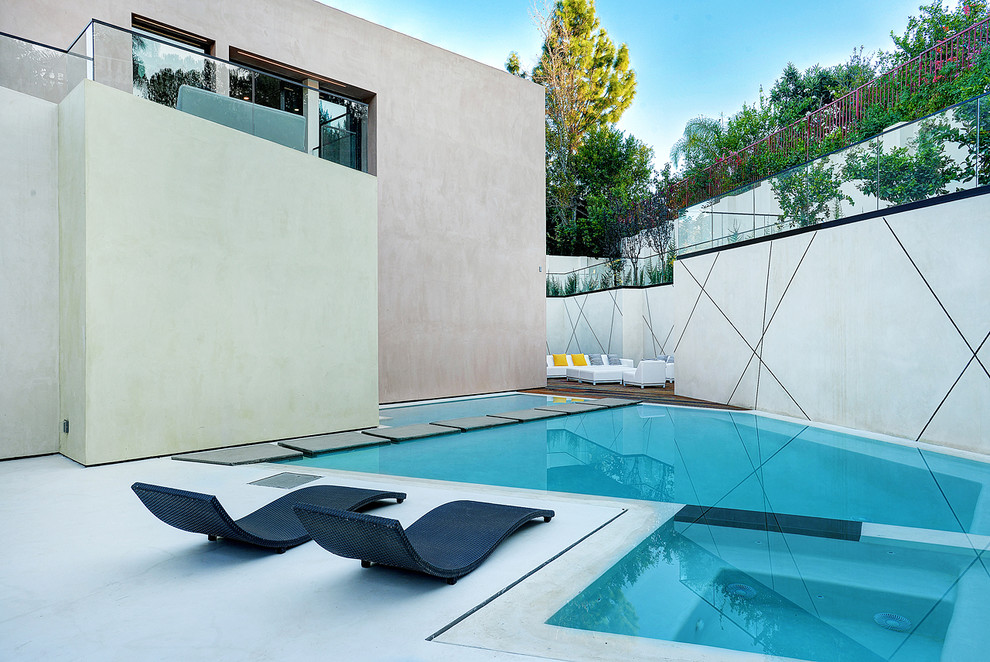 Contemporary side yard custom-shaped pool in Los Angeles with a hot tub.
