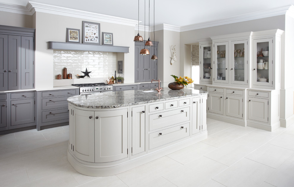 Photo of a traditional l-shaped kitchen in West Midlands with an undermount sink, beaded inset cabinets, grey cabinets, white splashback, subway tile splashback, stainless steel appliances, with island, white floor and white benchtop.