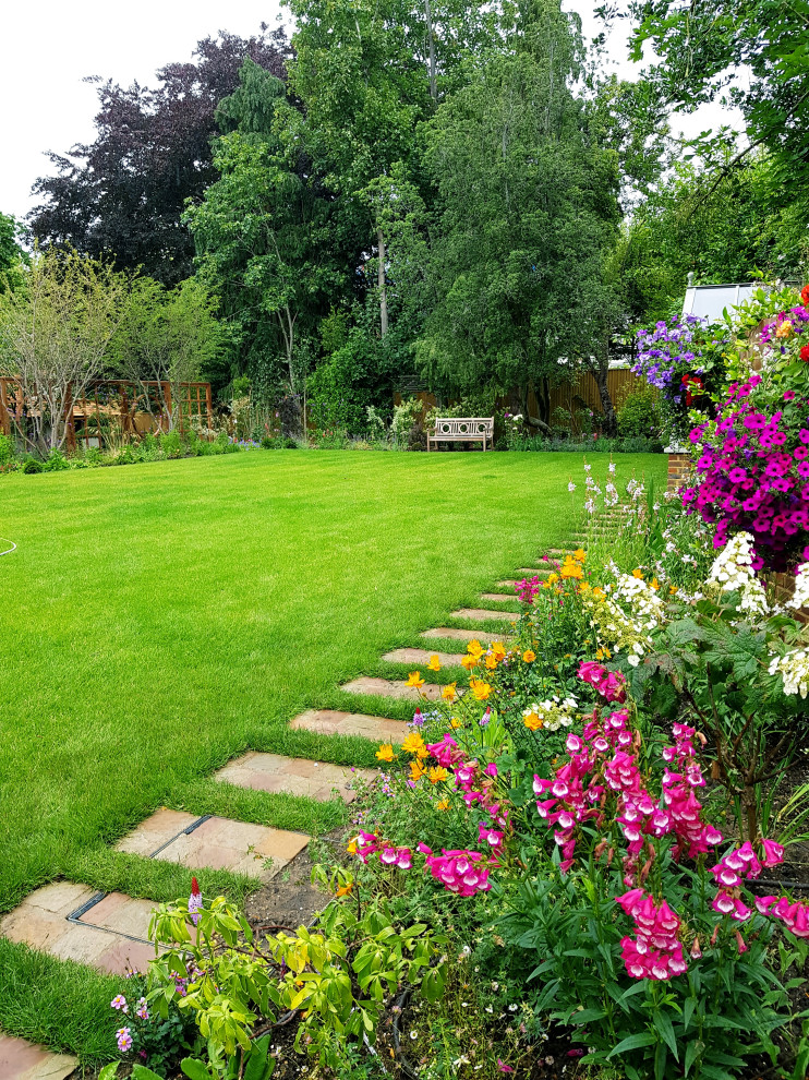 Photo of a large asian backyard formal garden in London with with flowerbed.