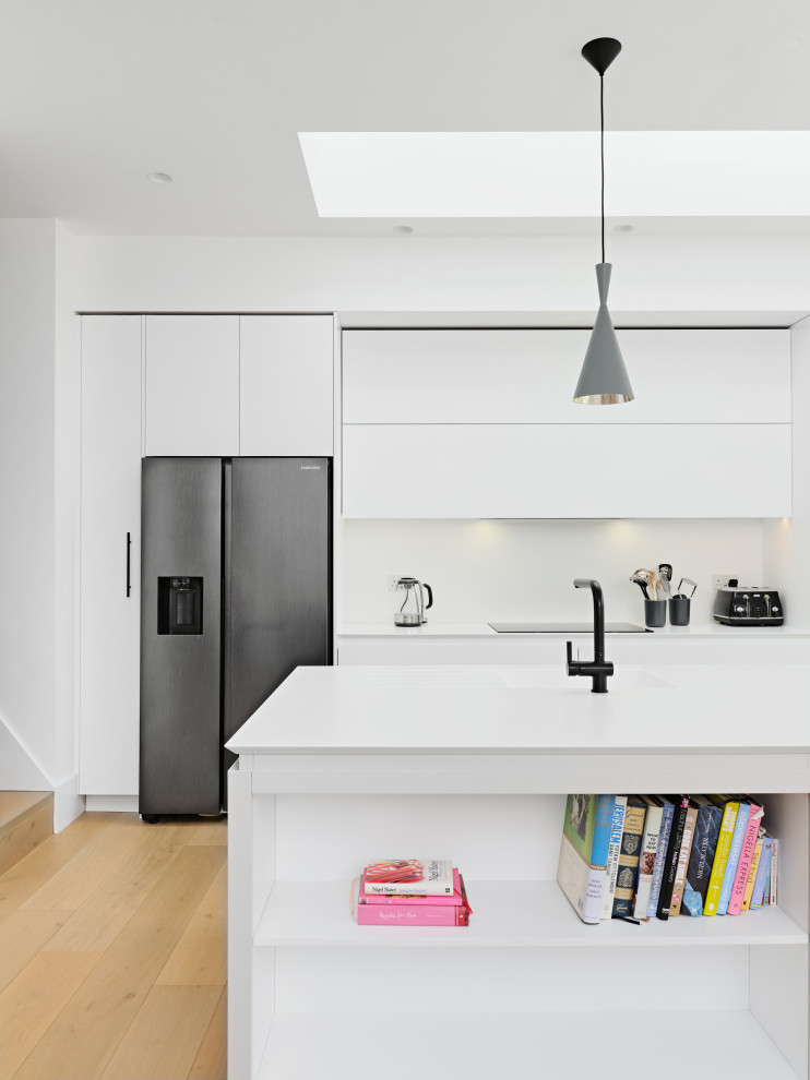 Immagine di una cucina contemporanea di medie dimensioni con ante lisce, ante bianche e top bianco