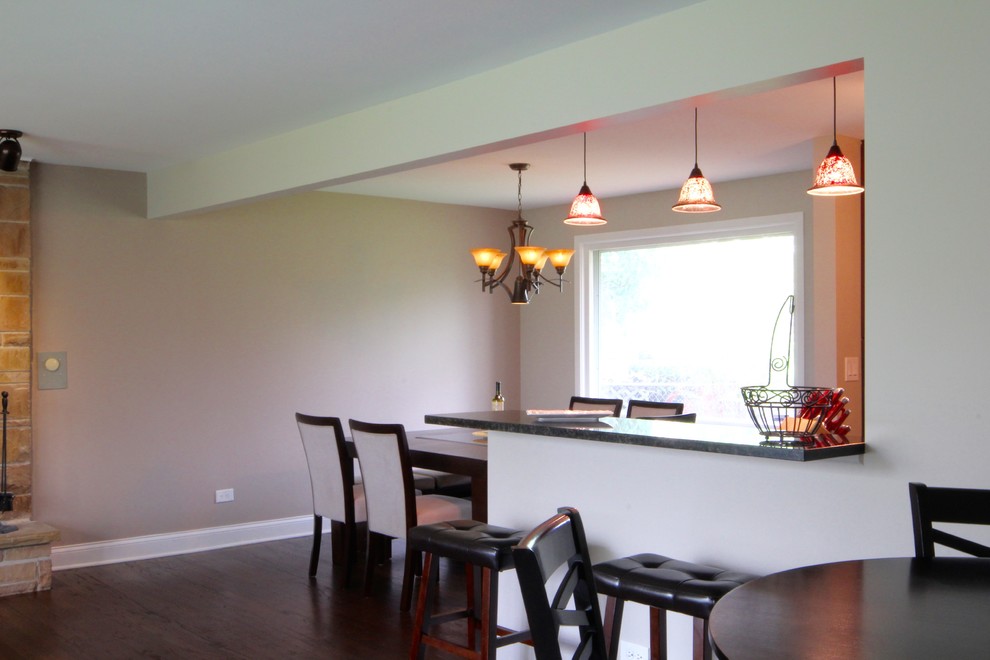 Example of a large transitional galley dark wood floor and beige floor eat-in kitchen design in Chicago with an undermount sink, raised-panel cabinets, red cabinets, granite countertops, brown backsplash, matchstick tile backsplash, stainless steel appliances and no island