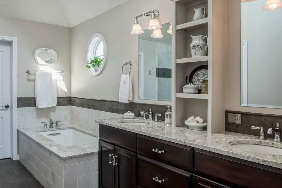 This is an example of a mid-sized transitional master bathroom in Chicago with an undermount sink, flat-panel cabinets, dark wood cabinets, granite benchtops, an undermount tub, an alcove shower, a two-piece toilet, porcelain tile, beige walls, porcelain floors and beige tile.
