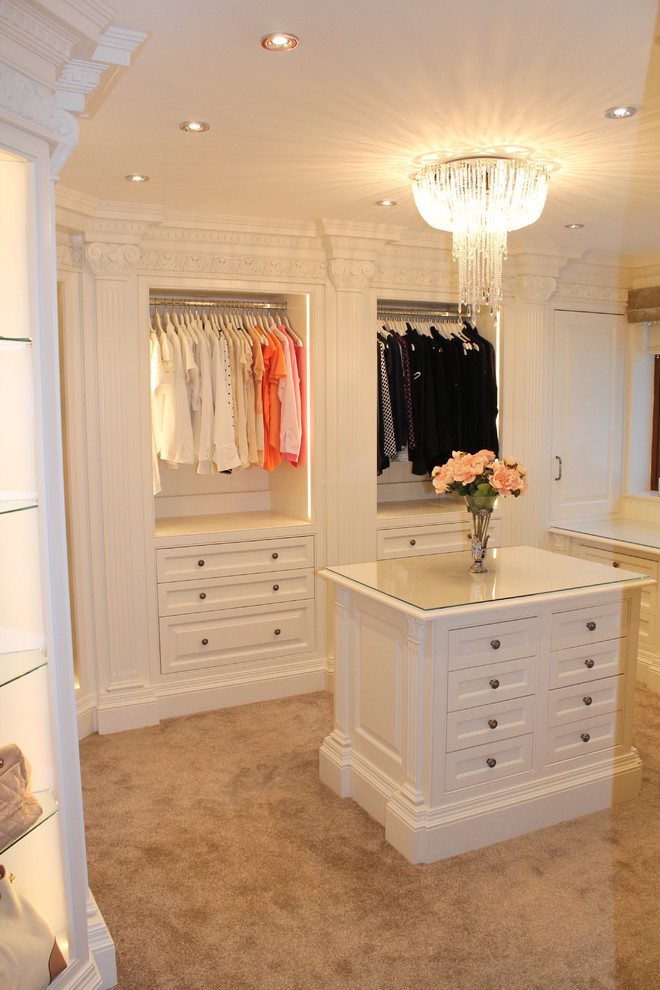 Traditional dressing room in Essex with raised-panel cabinets and white cabinets.