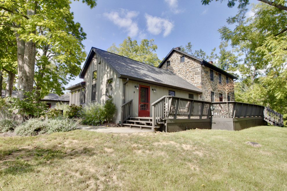 Esempio della facciata di una casa verde country con rivestimento con lastre in cemento e pannelli e listelle di legno