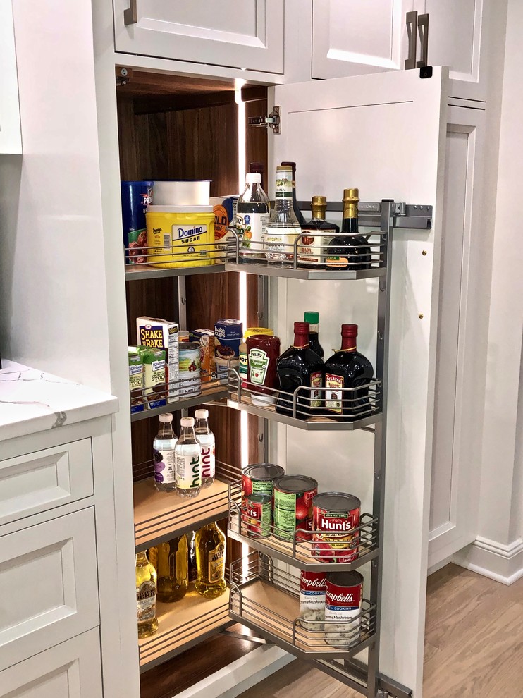 Example of a large transitional medium tone wood floor and beige floor eat-in kitchen design in New York with beaded inset cabinets, gray cabinets, quartz countertops, an island, multicolored backsplash, marble backsplash, stainless steel appliances and white countertops