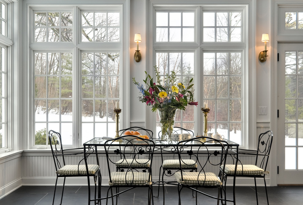 Inspiration for a traditional dining room in New York with slate floors and black floor.