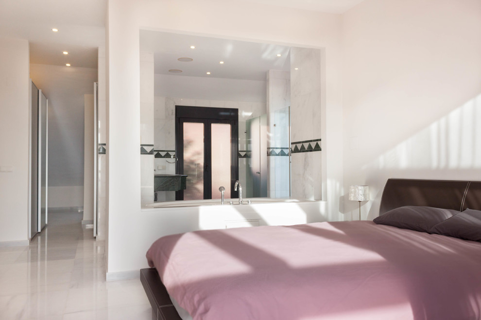 Photo of a large scandinavian master bedroom in Malaga with white walls, marble floors and grey floor.