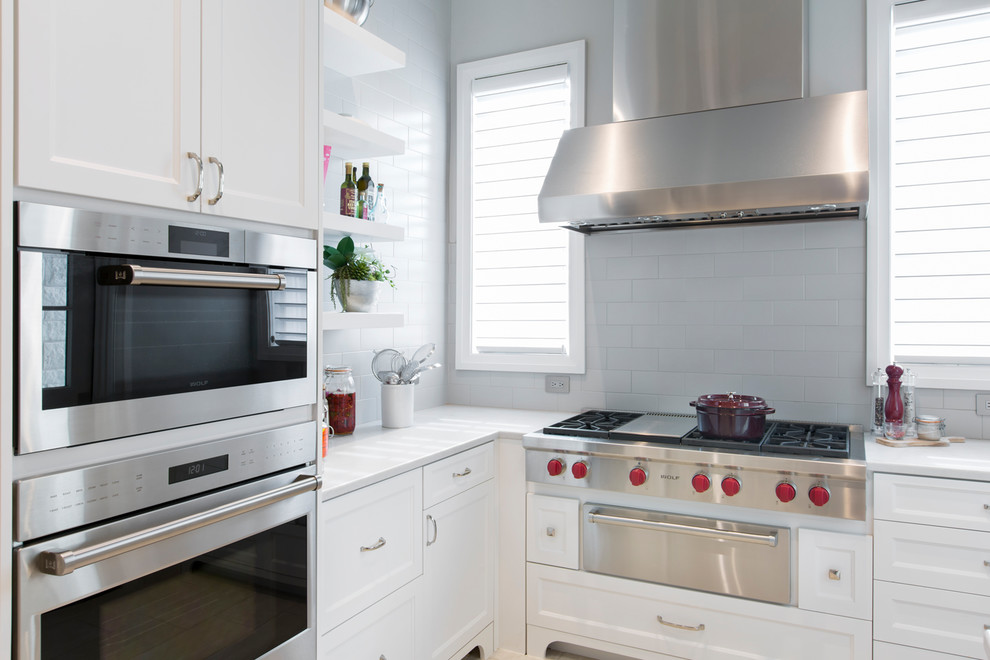 Transitional kitchen photo with white cabinets and white countertops