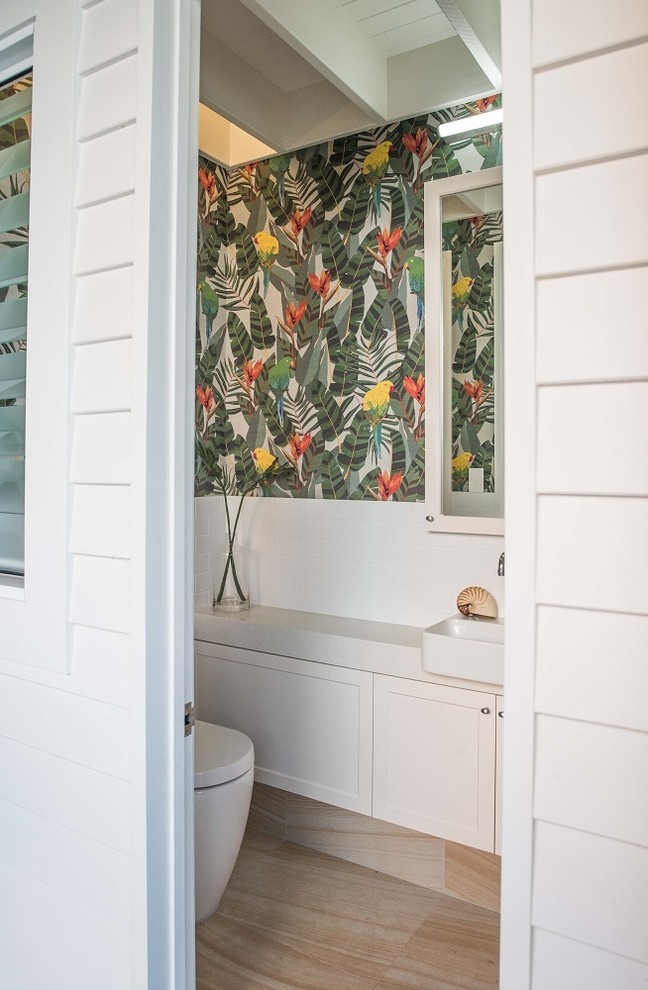Photo of a small beach style powder room in Sunshine Coast with white tile, a drop-in sink and engineered quartz benchtops.