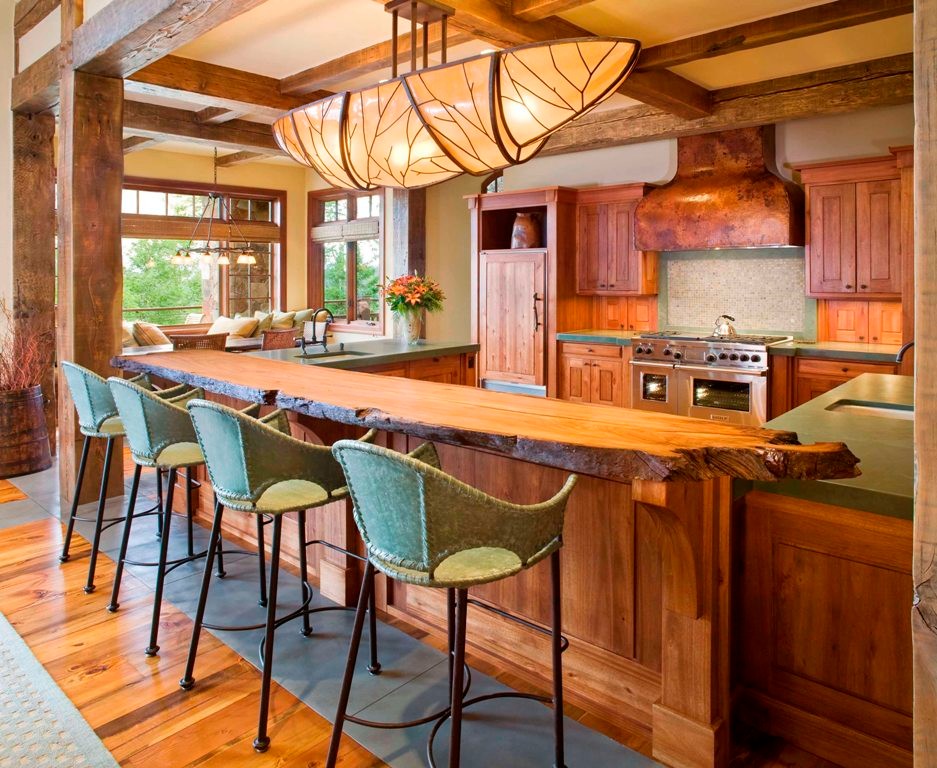 This is an example of a large country l-shaped open plan kitchen in Denver with an undermount sink, shaker cabinets, medium wood cabinets, quartz benchtops, green splashback, stone tile splashback, panelled appliances, medium hardwood floors, with island, brown floor and green benchtop.
