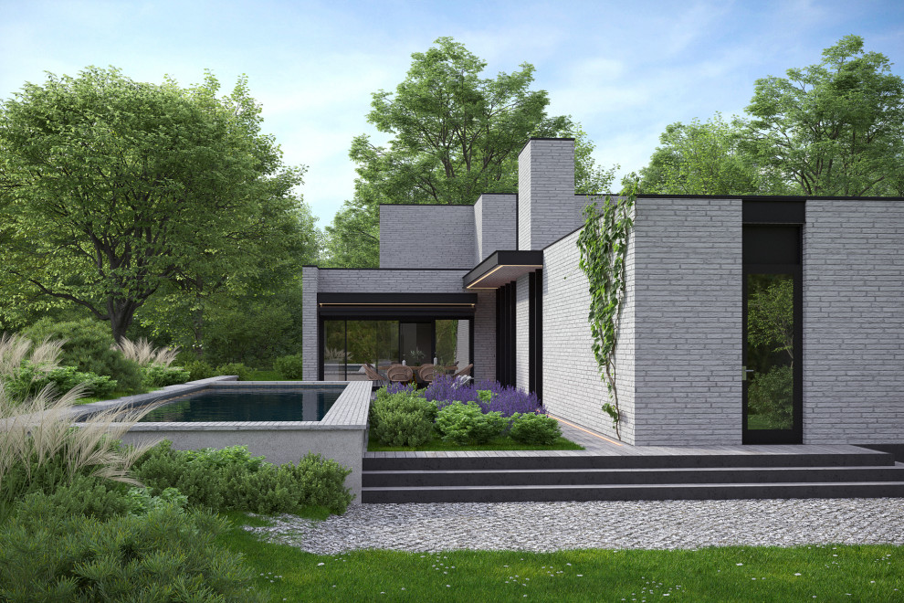 Свежая идея для дизайна: двухэтажный, кирпичный дом среднего размера в современном стиле с плоской крышей - отличное фото интерьера