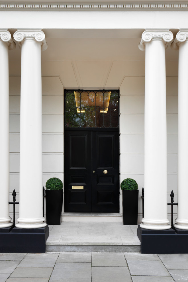 Design ideas for an expansive traditional two-storey white exterior in London.