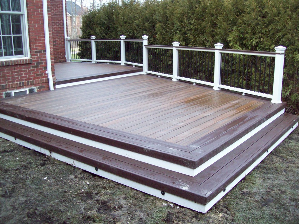 Large transitional backyard deck in Detroit with no cover.