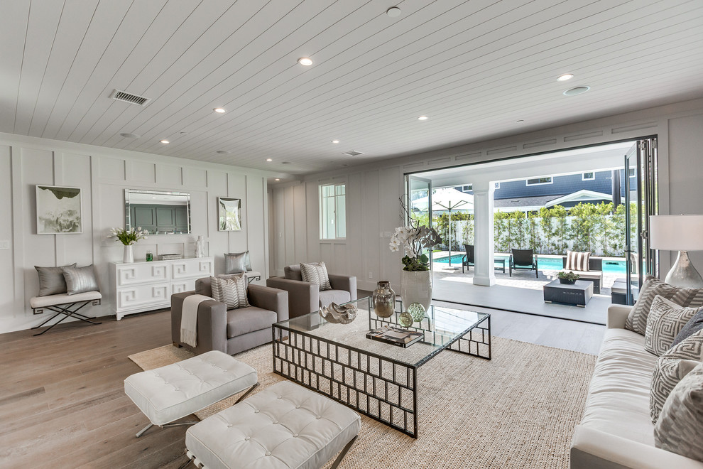 Living room - large transitional medium tone wood floor and brown floor living room idea in Los Angeles with gray walls