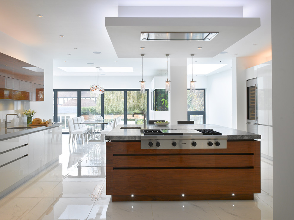 Inspiration for a large contemporary eat-in kitchen in London with flat-panel cabinets, white cabinets, marble benchtops, grey splashback, glass sheet splashback, stainless steel appliances, ceramic floors, with island, white floor and grey benchtop.