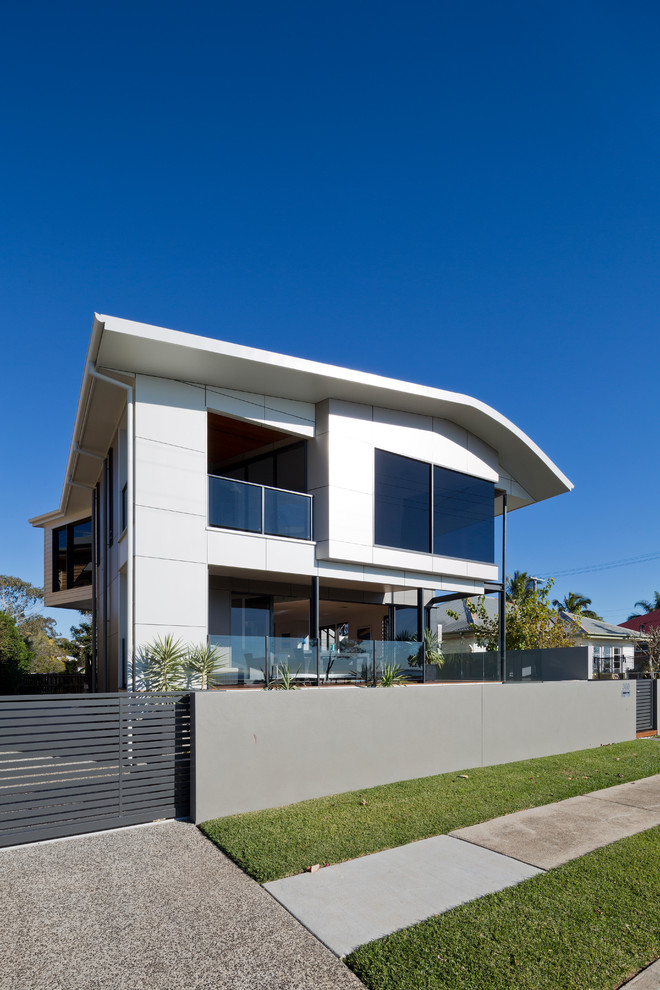 Design ideas for a mid-sized modern two-storey white exterior in Brisbane.