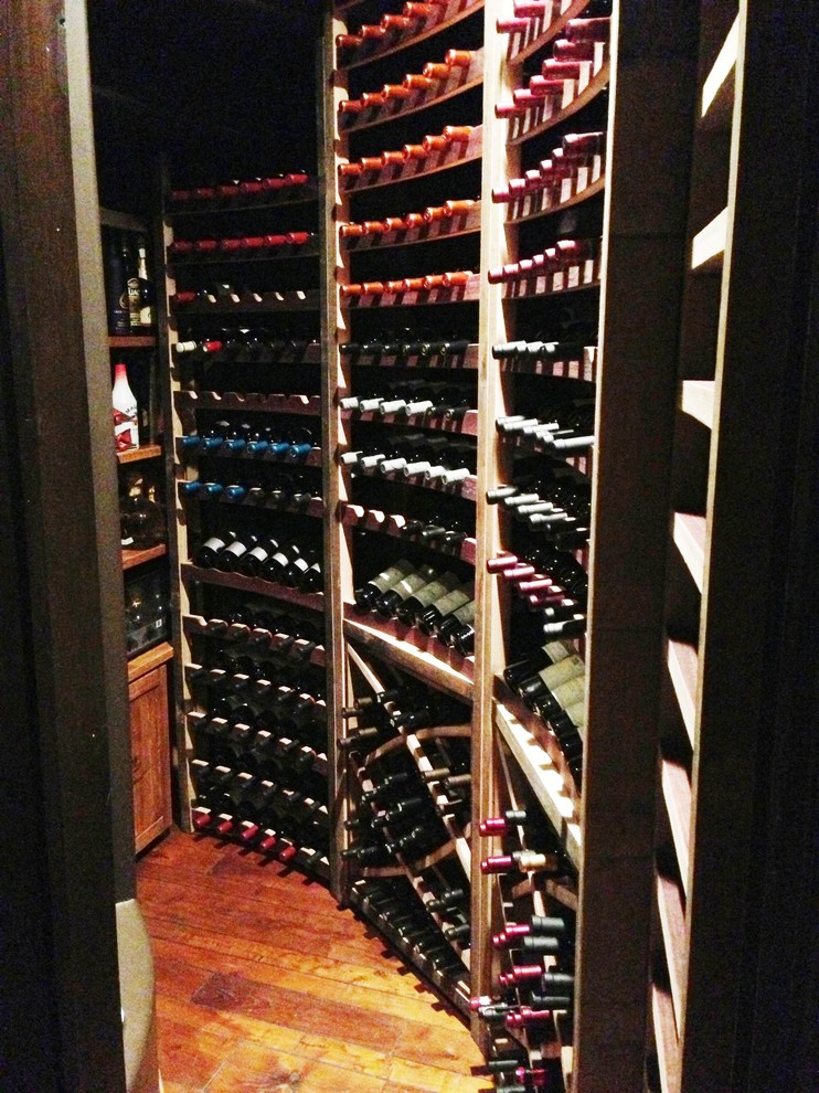 Design ideas for a small eclectic wine cellar in Los Angeles with concrete floors and storage racks.