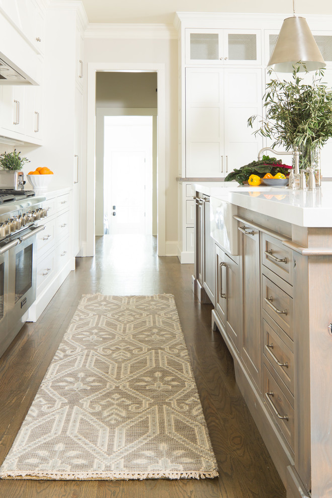 Design ideas for a traditional kitchen in Atlanta with a farmhouse sink, quartz benchtops, white splashback, ceramic splashback, stainless steel appliances, with island and white benchtop.