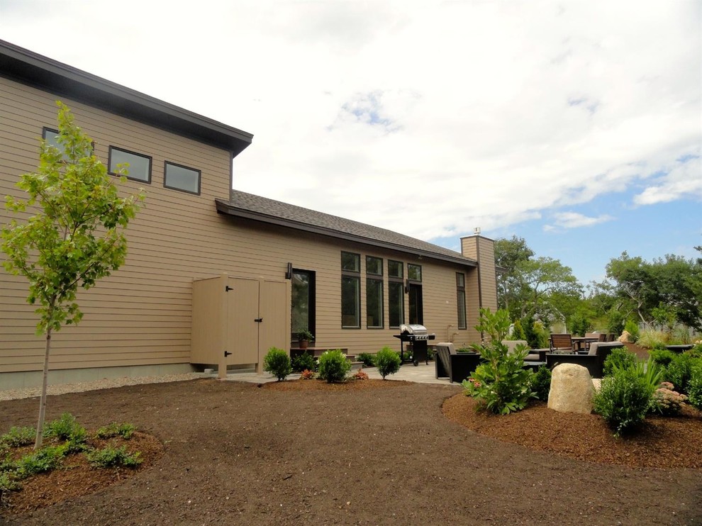 This is an example of a mid-sized contemporary two-storey beige exterior in Boston with concrete fiberboard siding.