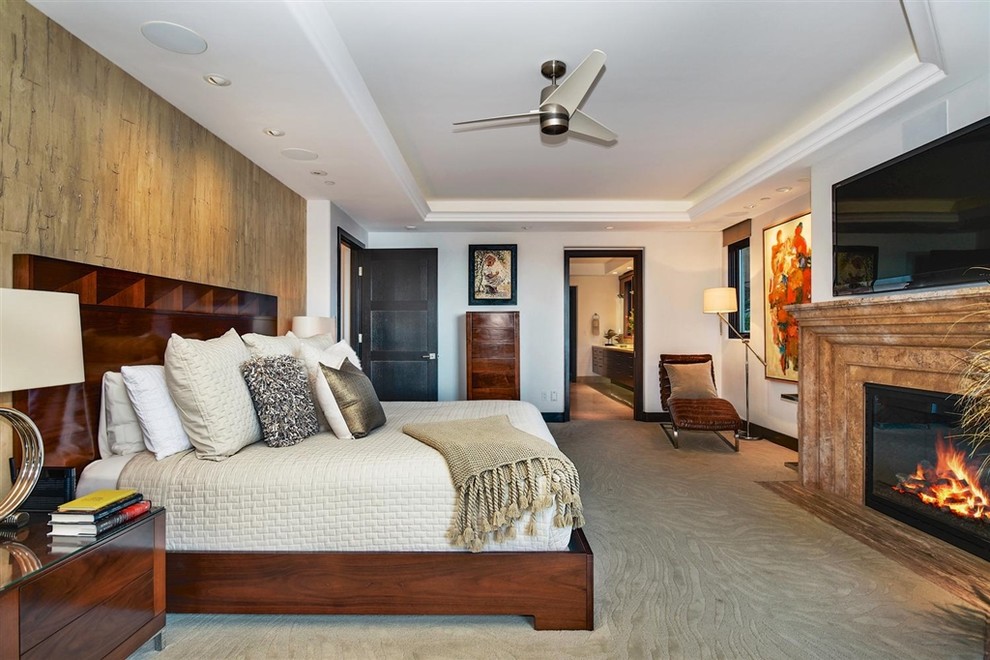 Contemporary master bedroom in San Diego with white walls, carpet, a ribbon fireplace and beige floor.