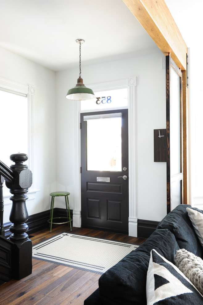 Design ideas for a mid-sized eclectic front door in Vancouver with white walls, a single front door and a black front door.