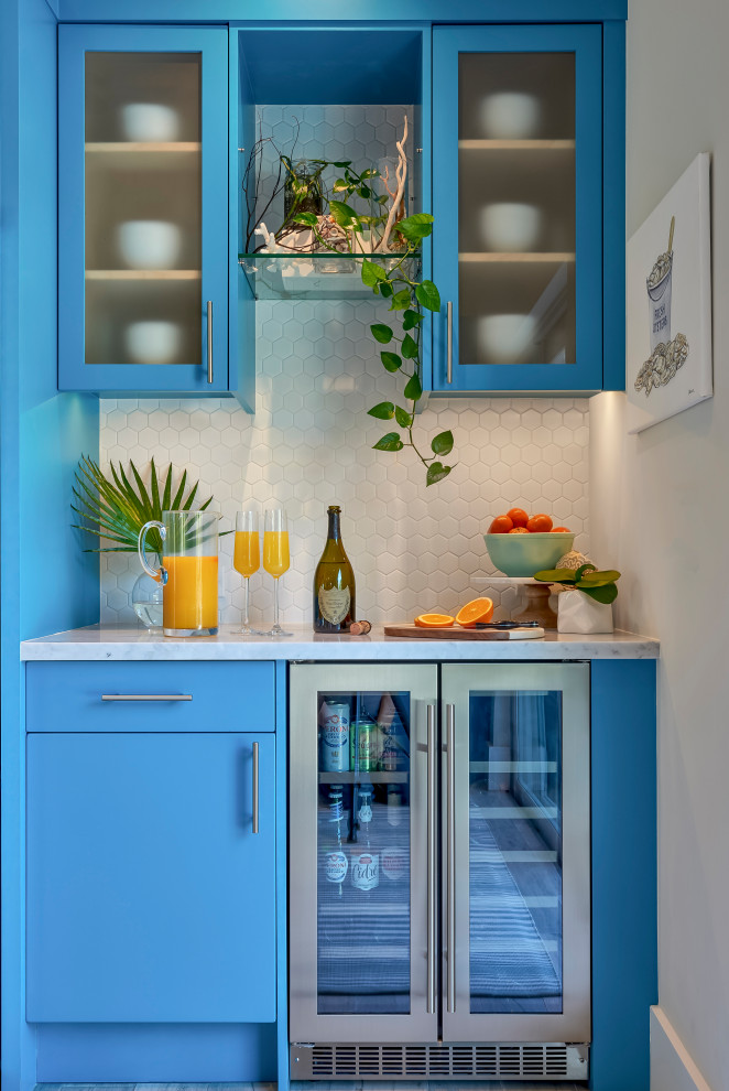 Design ideas for a beach style home bar in Miami with flat-panel cabinets, blue cabinets, white splashback, mosaic tile splashback and white benchtop.