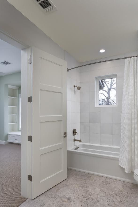This is an example of a mid-sized transitional 3/4 bathroom in Austin with shaker cabinets, white cabinets, white walls, an alcove tub, white tile, granite benchtops, brown floor, grey benchtops, an alcove shower, ceramic tile, an undermount sink, an open shower, a single vanity and a built-in vanity.