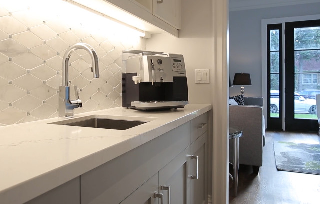 Inspiration for a large transitional galley medium tone wood floor kitchen pantry remodel in Toronto with an undermount sink, shaker cabinets, gray cabinets, quartz countertops, white backsplash, mosaic tile backsplash, stainless steel appliances and an island