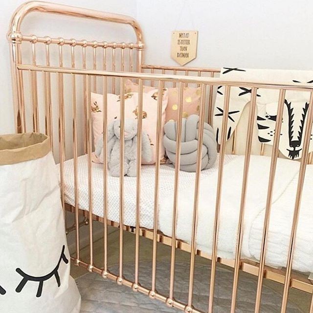 Design ideas for a scandinavian nursery for girls in Los Angeles with beige walls and carpet.