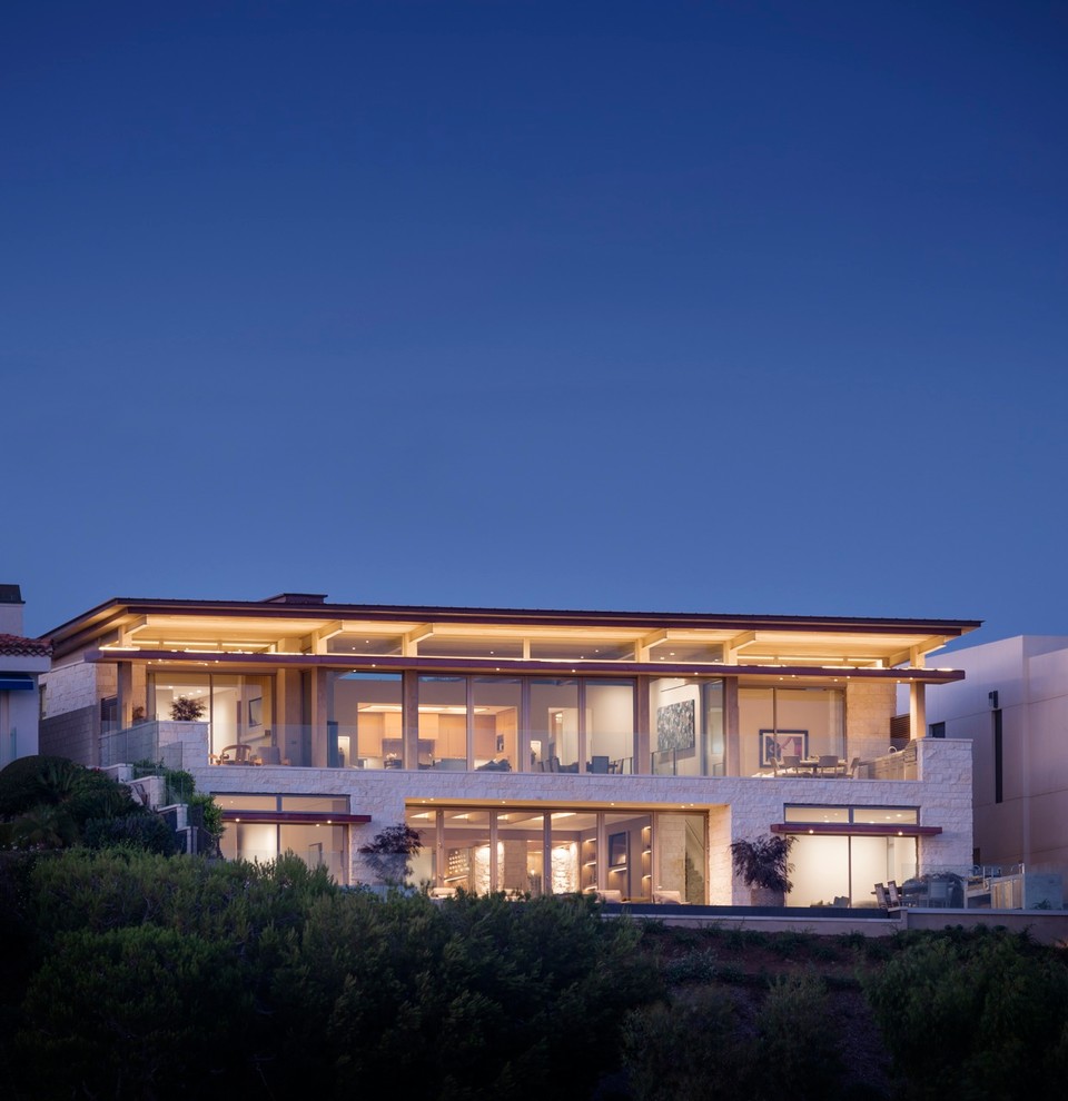 Contemporary two-storey glass exterior in Orange County with a flat roof.