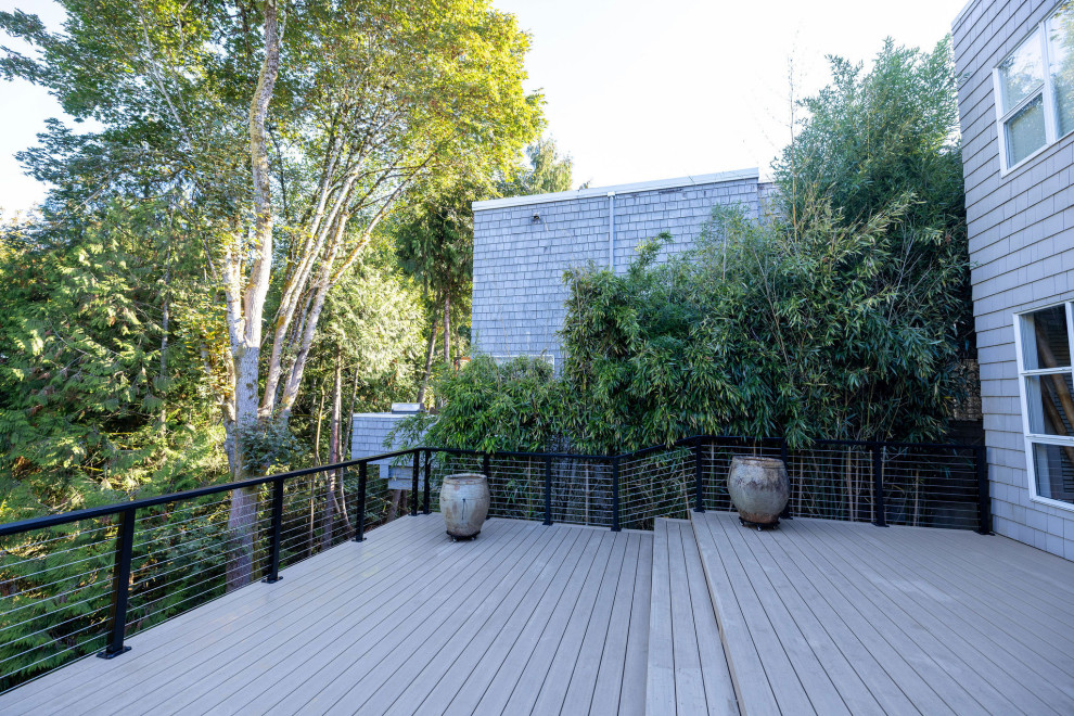 Deck - mid-sized backyard second story cable railing deck idea in Seattle