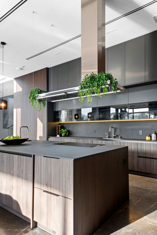 This is an example of an expansive modern l-shaped kitchen/diner in Miami with flat-panel cabinets, medium wood cabinets, engineered stone countertops, black splashback, engineered quartz splashback, an island and black worktops.