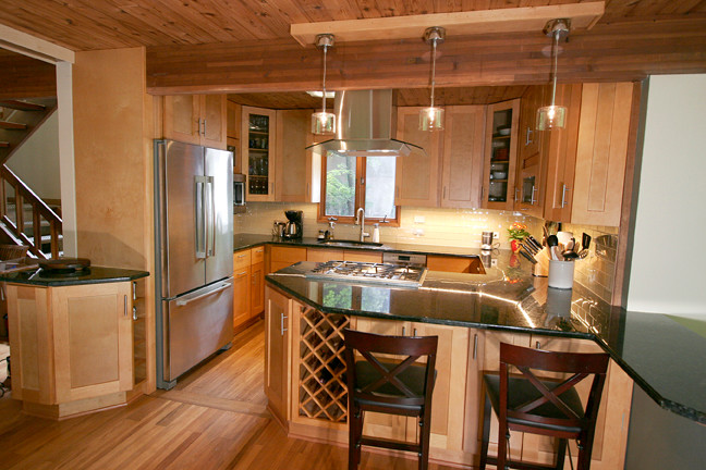 Inspiration for a small transitional l-shaped porcelain tile eat-in kitchen remodel with shaker cabinets, light wood cabinets, granite countertops, beige backsplash, glass tile backsplash, stainless steel appliances and a peninsula
