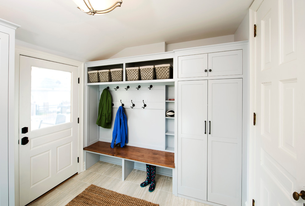Design ideas for a mid-sized transitional mudroom in Minneapolis with blue walls, ceramic floors, a single front door, a white front door and beige floor.