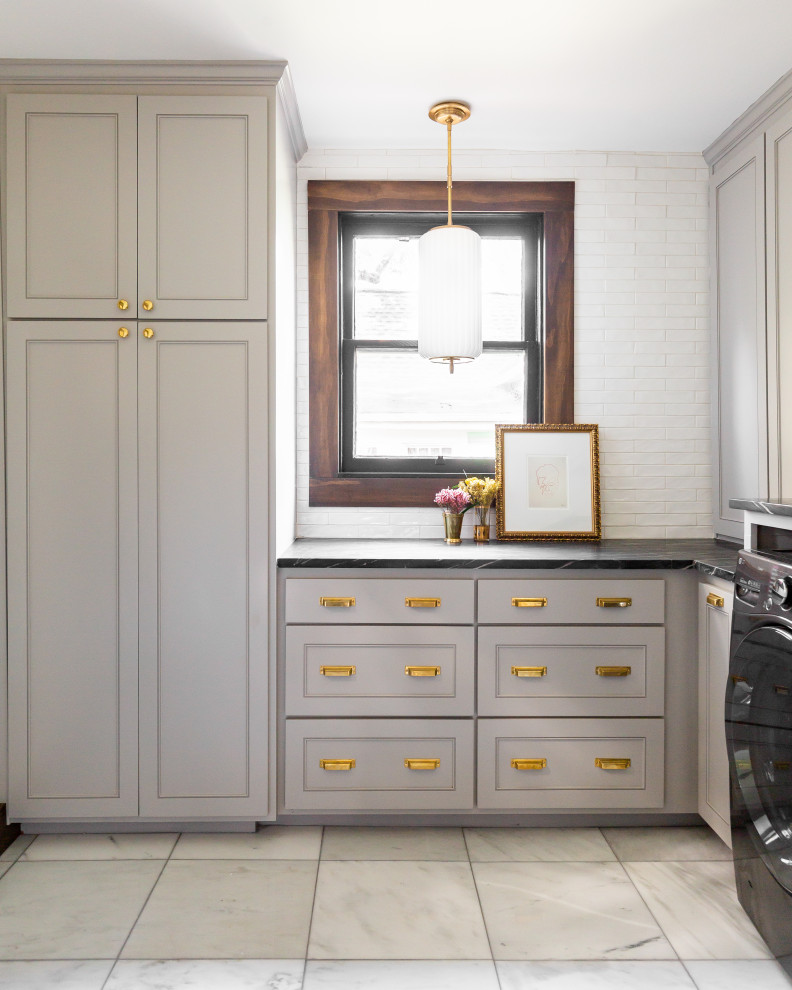 Inspiration for a medium sized victorian separated utility room in Dallas with beige cabinets, white splashback, brick splashback, beige walls, a side by side washer and dryer, beige floors and black worktops.