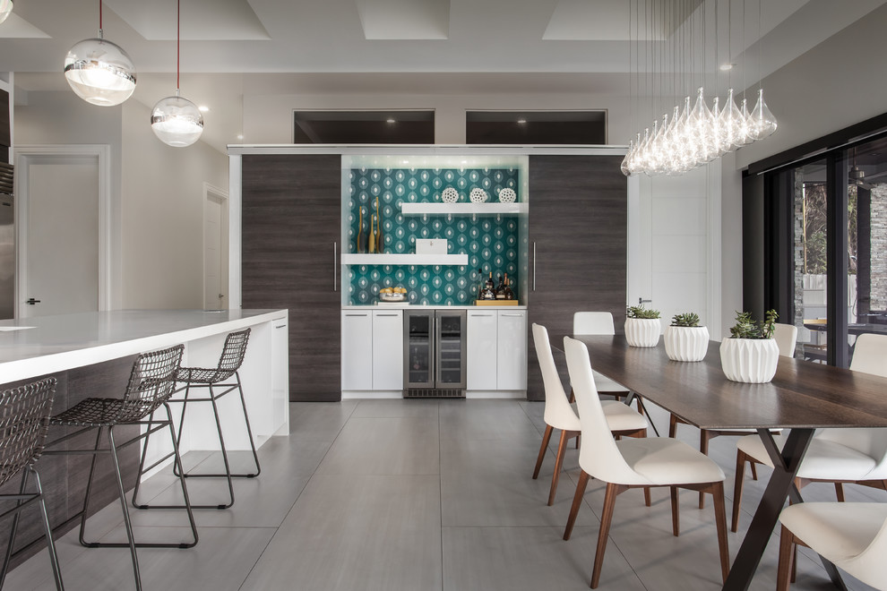 Design ideas for a contemporary single-wall home bar in Miami with no sink, flat-panel cabinets, white cabinets, multi-coloured splashback and grey floor.