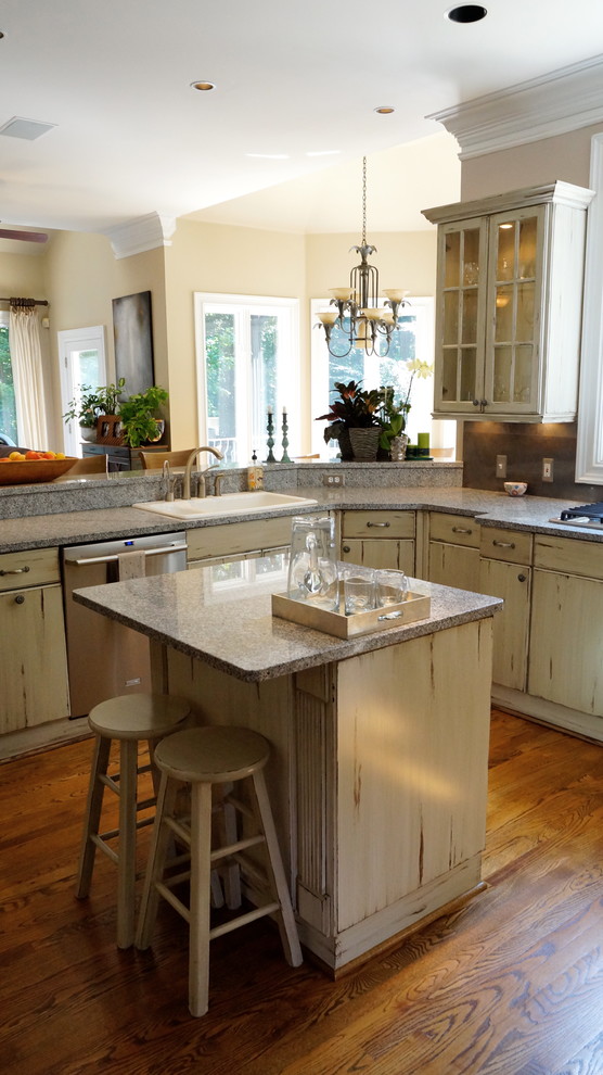 Large mountain style u-shaped medium tone wood floor eat-in kitchen photo in Atlanta with an undermount sink, flat-panel cabinets, distressed cabinets, quartz countertops, white backsplash, ceramic backsplash, stainless steel appliances and beige walls