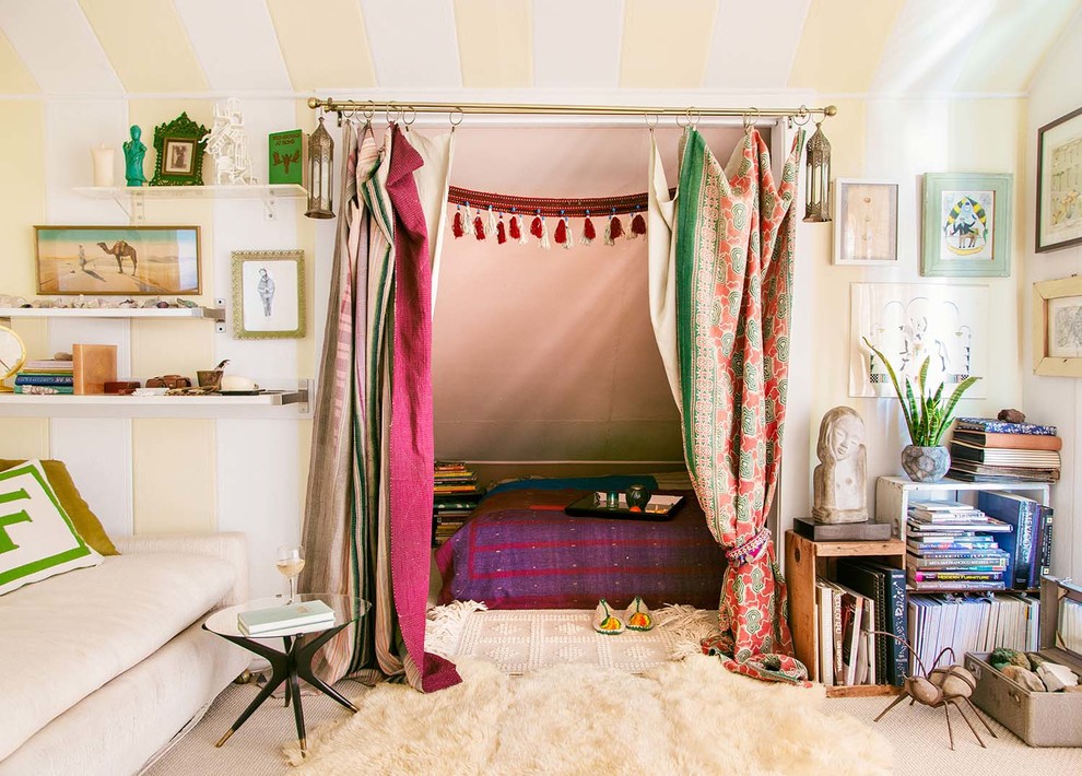 Photo of an eclectic bedroom in Los Angeles with beige walls and carpet.