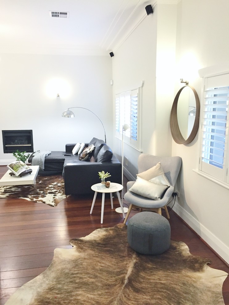 Inspiration for a mid-sized contemporary study room in Perth with grey walls, dark hardwood floors and a standard fireplace.