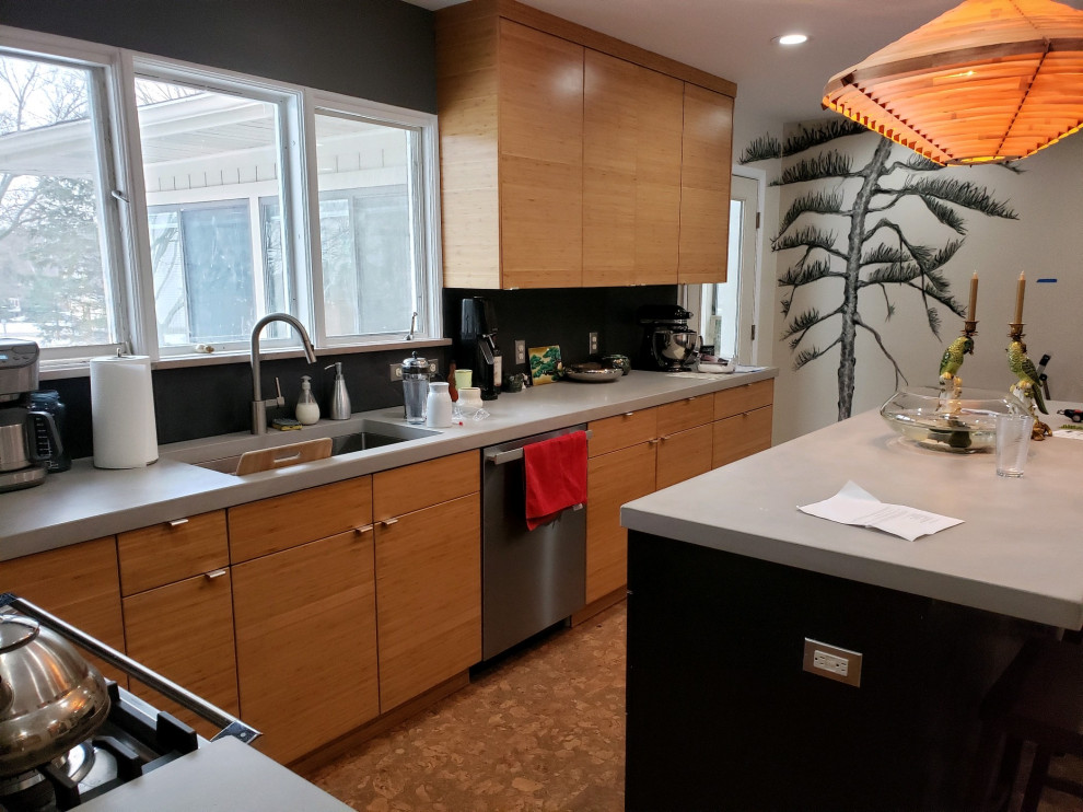 Design ideas for a midcentury kitchen in Grand Rapids with flat-panel cabinets, black cabinets, concrete benchtops, slate splashback and with island.