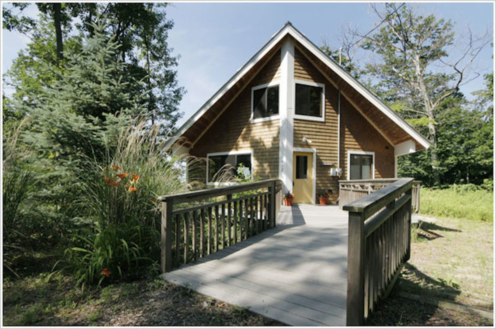 Inspiration for a small country two-storey brown exterior in Grand Rapids with wood siding.
