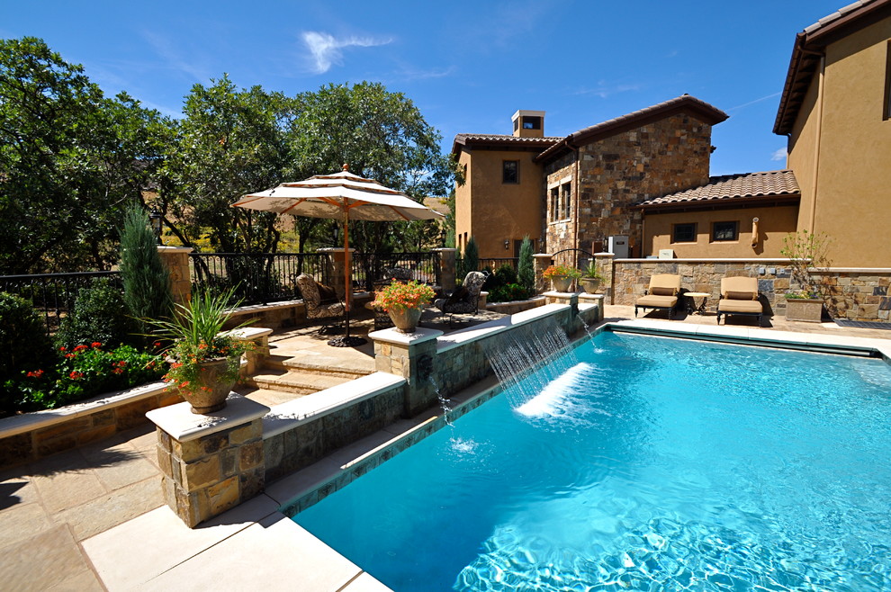 This is an example of a mid-sized traditional backyard l-shaped natural pool in Denver with a hot tub and tile.
