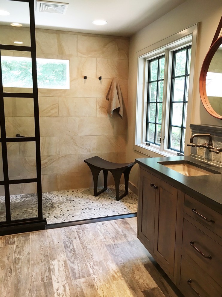 This is an example of a mid-sized industrial master bathroom in Philadelphia with an open shower, beige walls and granite benchtops.