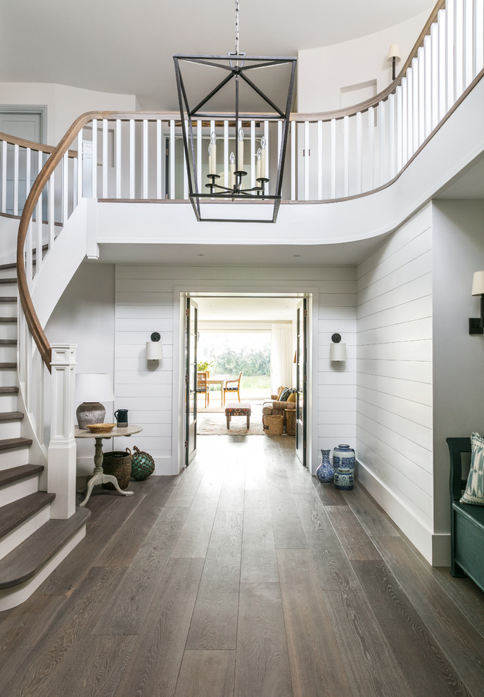 This is an example of an expansive beach style hallway in London with medium hardwood floors.