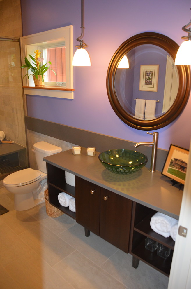 Photo of a mid-sized contemporary master bathroom in Cleveland with a vessel sink, open cabinets, dark wood cabinets, engineered quartz benchtops, gray tile, purple walls, a two-piece toilet, an alcove shower, porcelain tile, pebble tile floors and beige floor.