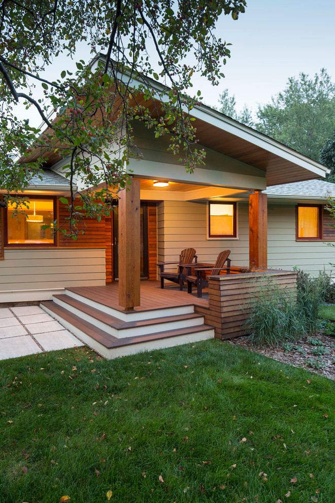 Inspiration for a mid-sized midcentury one-storey grey exterior in Minneapolis with mixed siding and a shed roof.