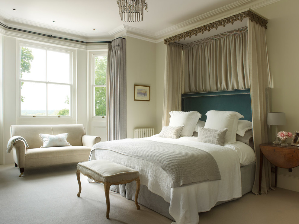 Traditional bedroom in Sussex with white walls and carpet.